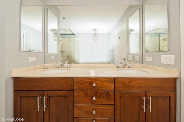 bathroom with a shower with door and vanity