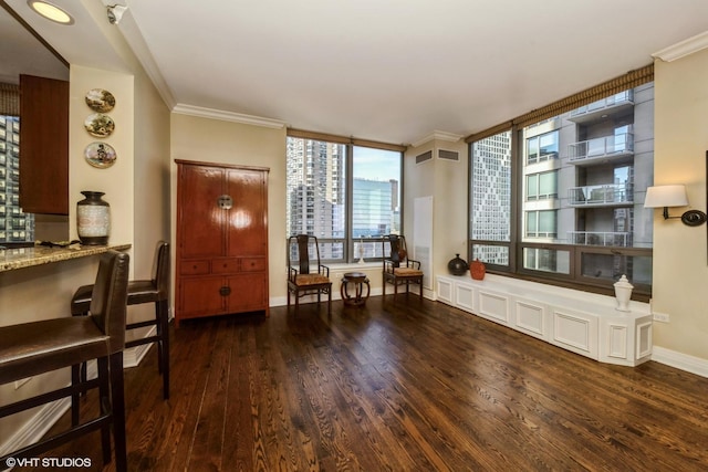 living area with crown molding and dark wood-type flooring