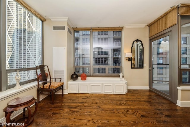 sitting room featuring ornamental molding and dark hardwood / wood-style floors