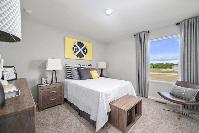 bedroom featuring light colored carpet