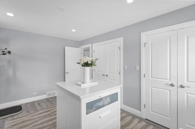 kitchen featuring light hardwood / wood-style floors and white cabinets