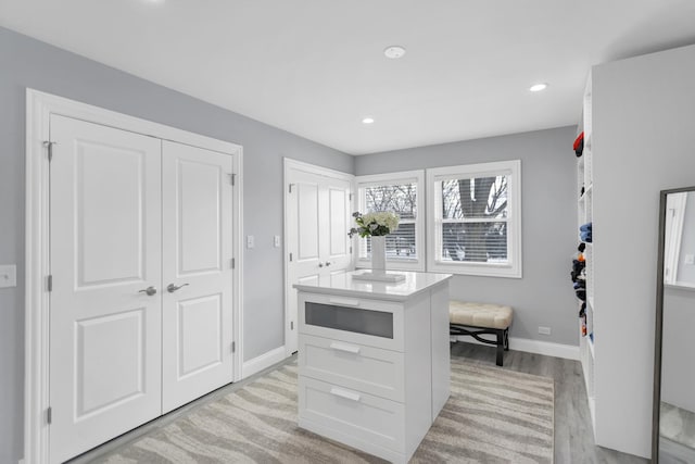 kitchen featuring light hardwood / wood-style floors and white cabinets