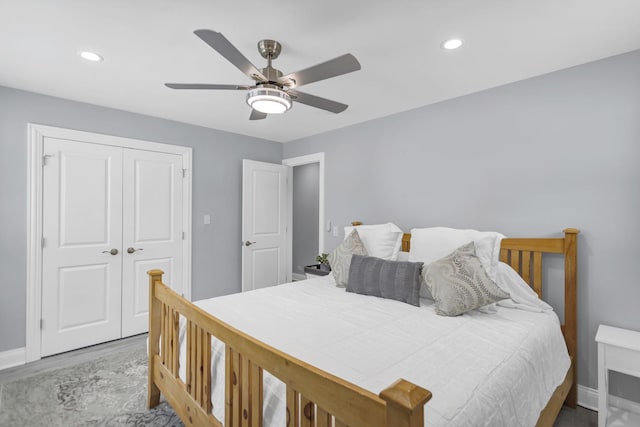 bedroom featuring hardwood / wood-style floors, ceiling fan, and a closet