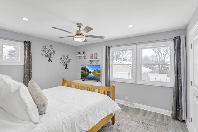 bedroom with ceiling fan and light hardwood / wood-style floors