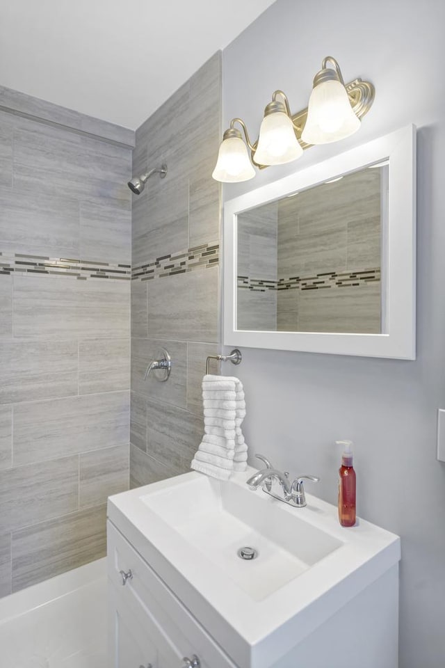 bathroom featuring vanity and a tile shower