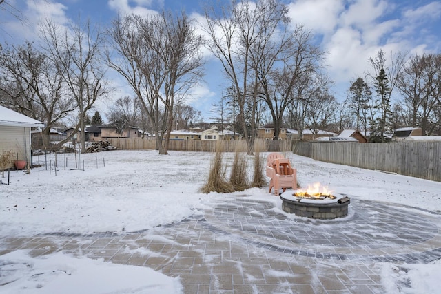 snowy yard featuring an outdoor fire pit