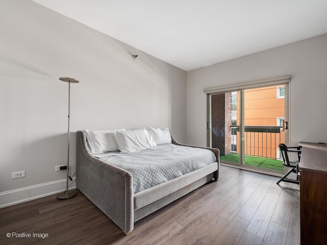 bedroom featuring dark hardwood / wood-style floors and access to outside