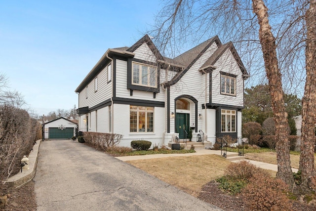 view of front of property featuring a garage and an outbuilding