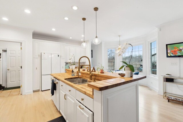 kitchen with white cabinetry, decorative light fixtures, and a kitchen breakfast bar