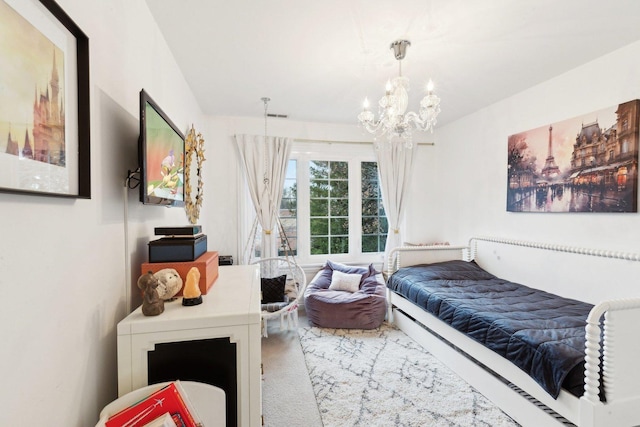 bedroom featuring carpet floors and a notable chandelier