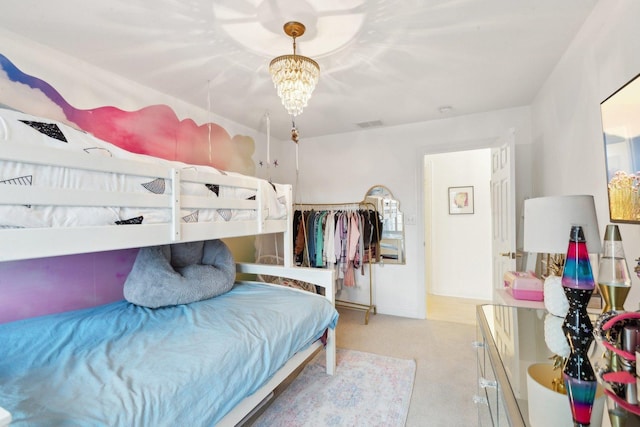 carpeted bedroom featuring a notable chandelier