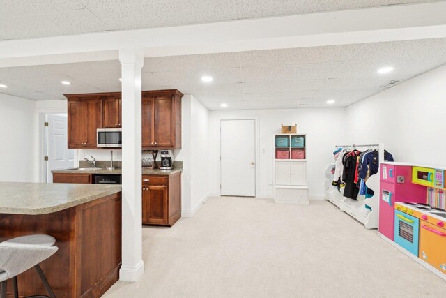 carpeted living room with a drop ceiling