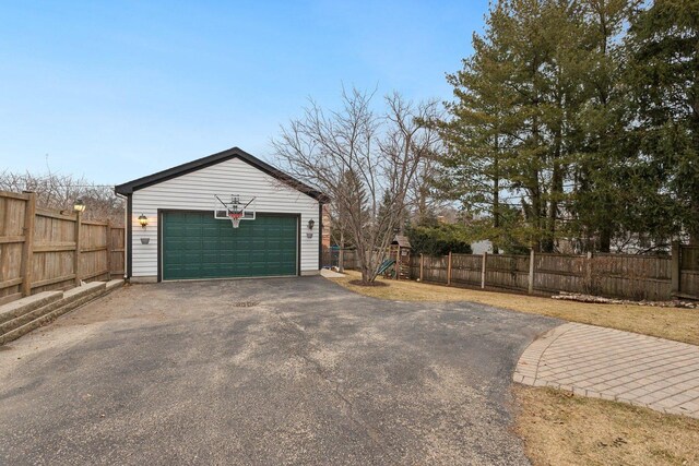 view of yard featuring a garage, an outdoor structure, and a playground