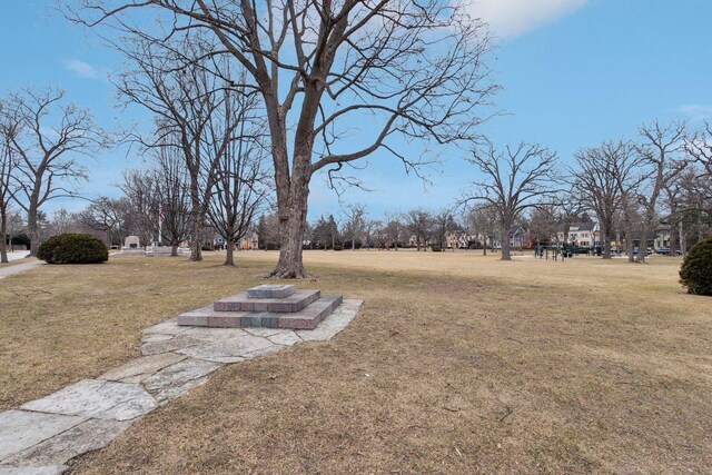 view of community featuring a playground and a lawn