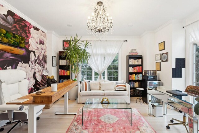 office featuring crown molding, a chandelier, and light wood-type flooring