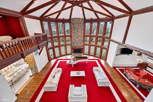 dining area featuring beam ceiling, a wealth of natural light, and high vaulted ceiling