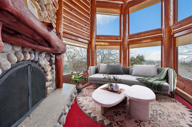 living room featuring a fireplace, a high ceiling, and a wealth of natural light