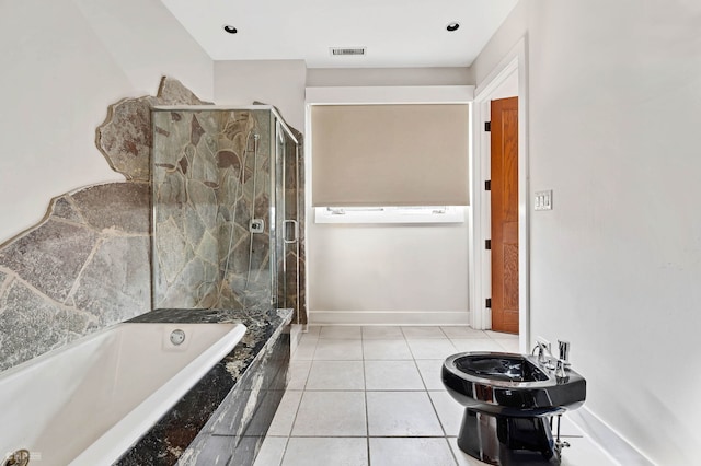 bathroom featuring tile patterned floors, toilet, and independent shower and bath