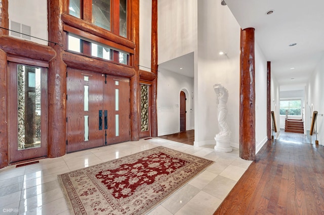 entrance foyer with a high ceiling and light hardwood / wood-style floors