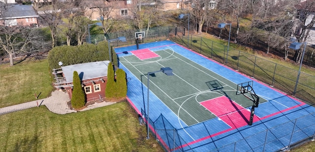 view of sport court with a lawn