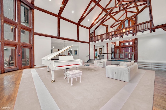 living room with high vaulted ceiling and light hardwood / wood-style flooring