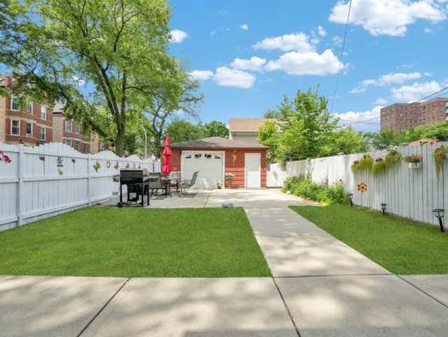 view of front of home featuring a garage, a patio, and a front yard