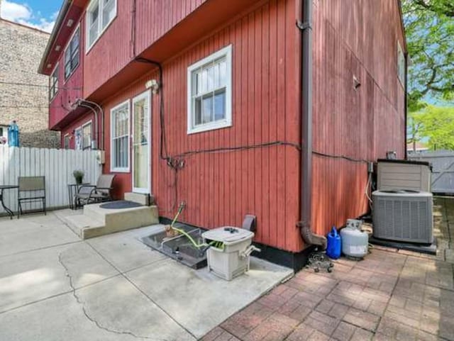 view of side of home featuring central AC unit and a patio area