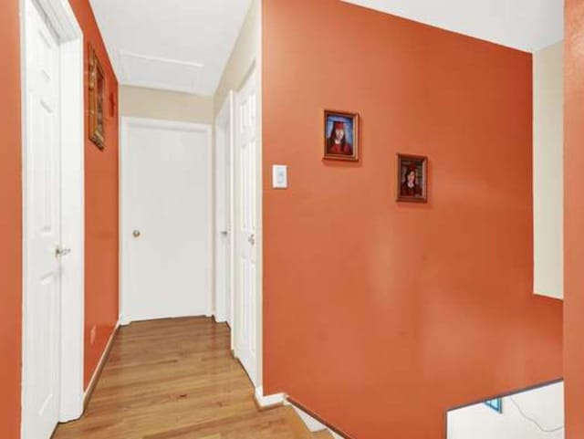 corridor with light hardwood / wood-style floors