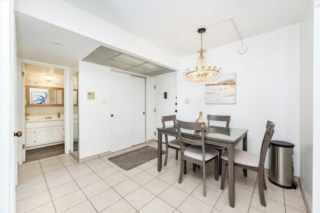 dining space featuring a chandelier and light tile patterned floors