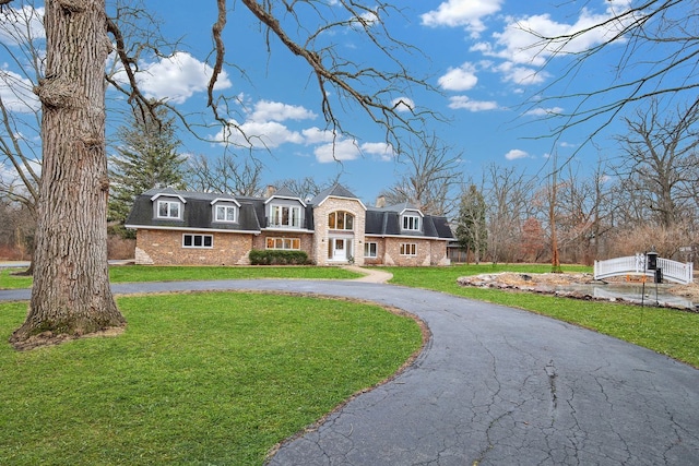 cape cod home with a front yard