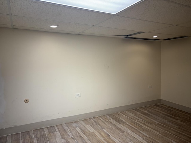 unfurnished room with a drop ceiling