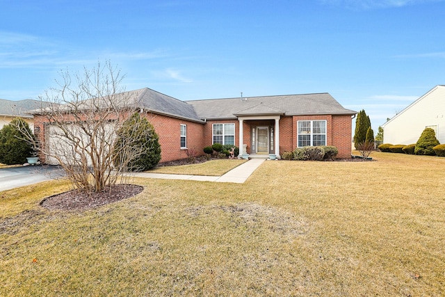 ranch-style house with a garage and a front lawn