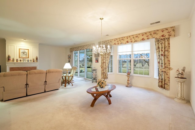 living room featuring ornamental molding, carpet flooring, and an inviting chandelier