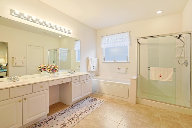 bathroom featuring tile patterned floors, independent shower and bath, and vanity