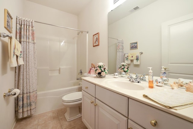 full bathroom featuring tile patterned flooring, vanity, toilet, and shower / bath combo with shower curtain