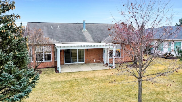 rear view of house featuring a patio and a lawn