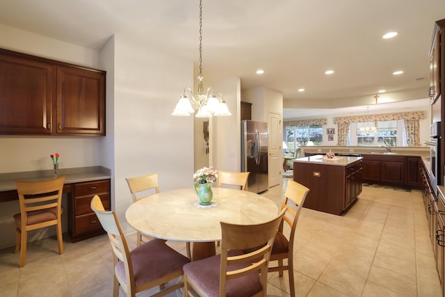 dining area with an inviting chandelier and light tile patterned floors