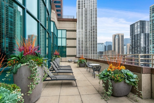 view of patio / terrace with a balcony and a city view