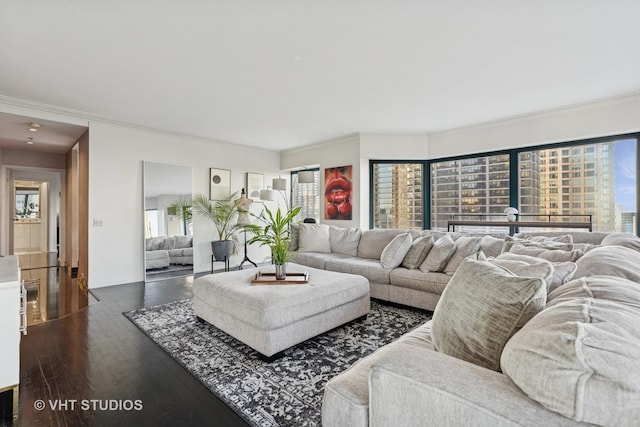 living area featuring dark wood-style floors, baseboards, a wealth of natural light, and crown molding