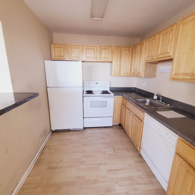 kitchen featuring white appliances, light brown cabinetry, sink, and light wood-type flooring