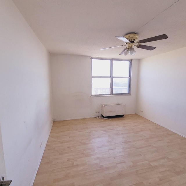 unfurnished room with light hardwood / wood-style floors and ceiling fan