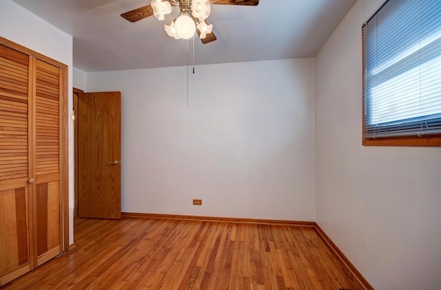 unfurnished bedroom featuring light hardwood / wood-style floors, a closet, and ceiling fan