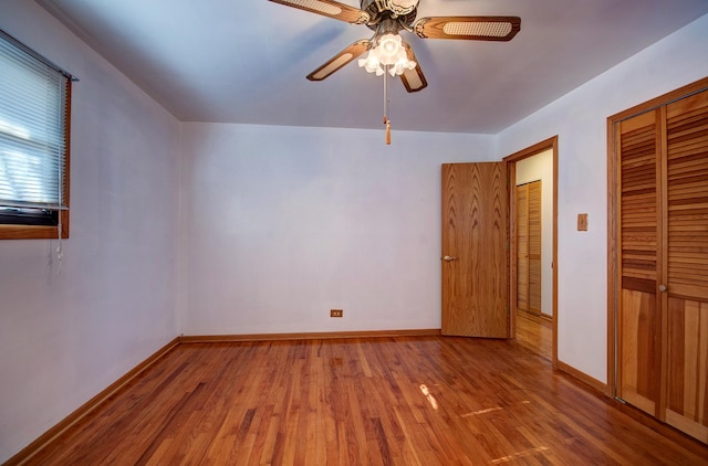 unfurnished bedroom featuring ceiling fan, wood-type flooring, and a closet