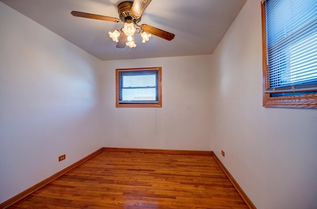 spare room featuring hardwood / wood-style flooring, a wealth of natural light, and ceiling fan