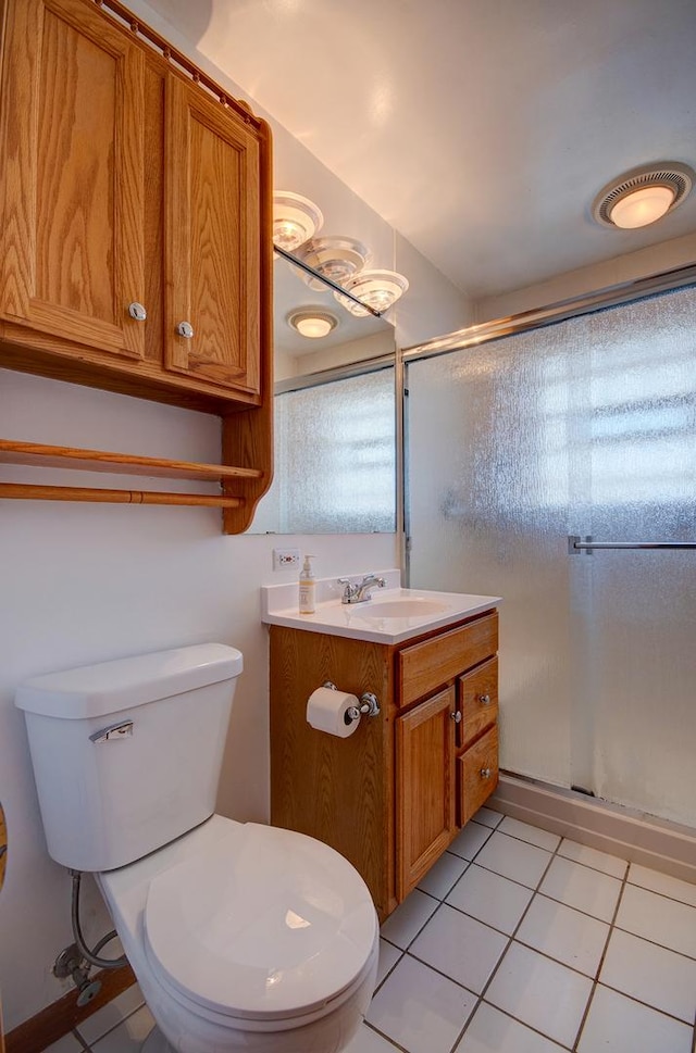 bathroom featuring walk in shower, tile patterned floors, toilet, and vanity