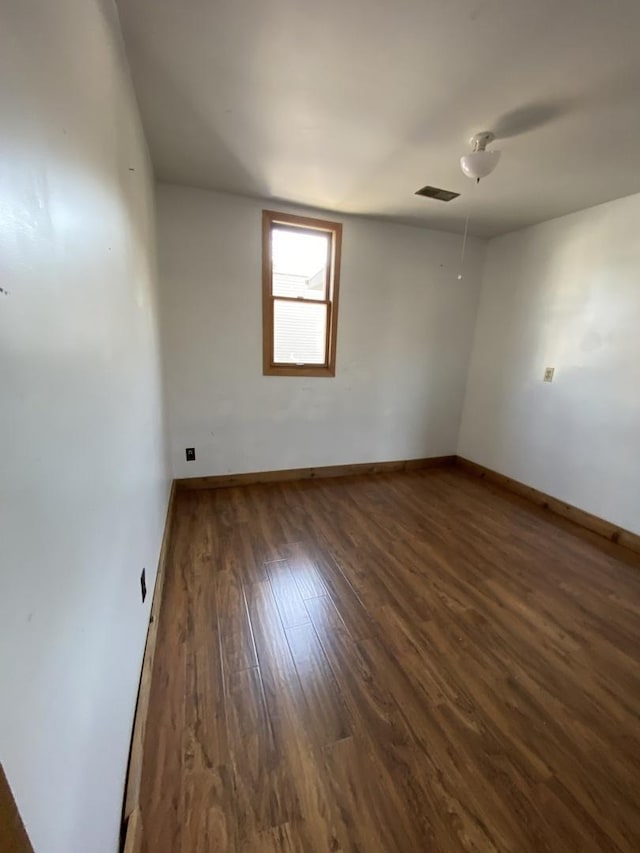 spare room featuring dark hardwood / wood-style flooring