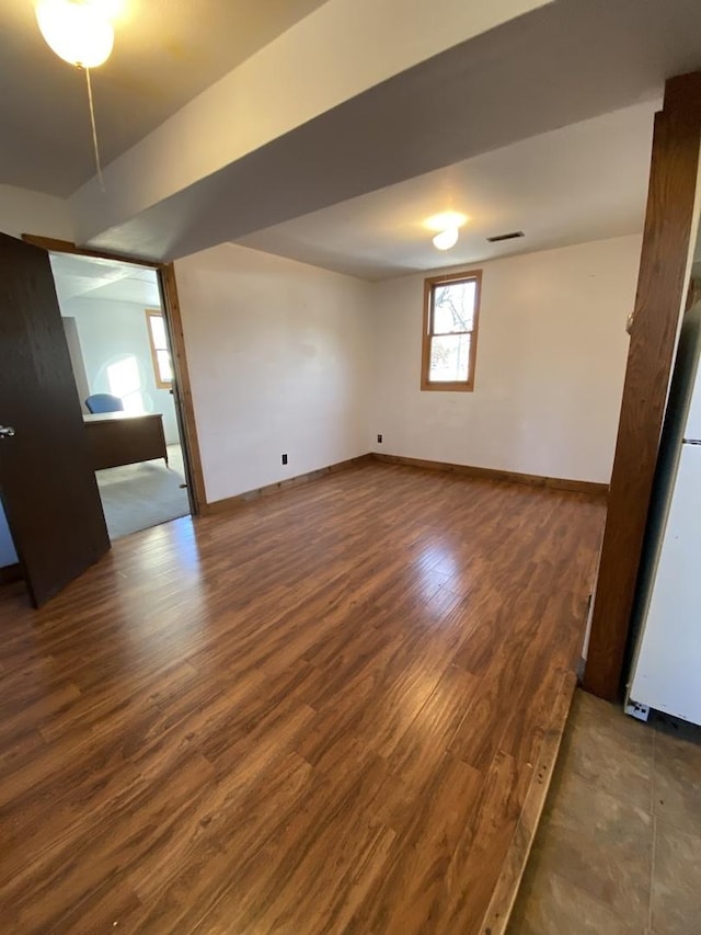 empty room featuring dark wood-type flooring