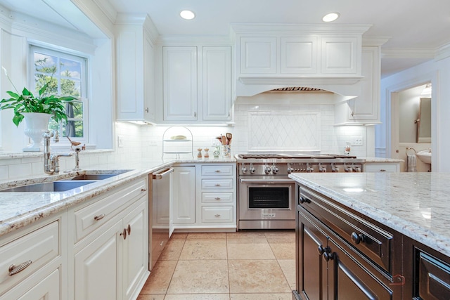 kitchen with white cabinetry, sink, tasteful backsplash, and appliances with stainless steel finishes