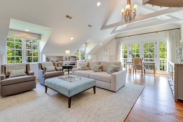 living room featuring high vaulted ceiling, a notable chandelier, light hardwood / wood-style floors, french doors, and beamed ceiling