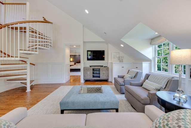 living room featuring lofted ceiling and light hardwood / wood-style flooring